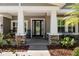 Inviting front porch with stone accents, rocking chairs, and a 'Welcome' sign that offers a warm greeting at 5313 Sanderling Ridge Dr, Lithia, FL 33547