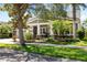 Charming single-story home with a well-manicured lawn, mature landscaping, and inviting front porch at 5313 Sanderling Ridge Dr, Lithia, FL 33547
