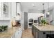 Bright kitchen featuring granite countertops, white cabinetry, and stainless steel appliances at 5313 Sanderling Ridge Dr, Lithia, FL 33547