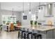 Open kitchen and dining area featuring an island with bar seating and modern lighting at 5313 Sanderling Ridge Dr, Lithia, FL 33547