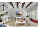 Bright living room featuring tile floors, a ceiling with wooden beams, and a large sectional sofa at 5313 Sanderling Ridge Dr, Lithia, FL 33547