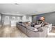 Spacious living room with comfortable oversized couch, entertainment center and clerestory windows at 5313 Sanderling Ridge Dr, Lithia, FL 33547