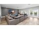 Spacious living room with comfortable oversized couch, entertainment center and outdoor access at 5313 Sanderling Ridge Dr, Lithia, FL 33547