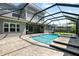 A screened-in swimming pool with an attached spa offers a luxurious outdoor retreat in a private backyard at 5313 Sanderling Ridge Dr, Lithia, FL 33547