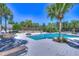 Leisure pool area with lounge chairs, pergola, and mature landscaping at 5313 Sanderling Ridge Dr, Lithia, FL 33547