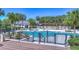 Resort-style pool with clear blue water, surrounded by lush landscaping and comfortable lounge chairs at 5313 Sanderling Ridge Dr, Lithia, FL 33547
