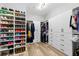 Spacious walk-in closet with custom built-in shelving, drawers, and ample storage for shoes and clothing at 5313 Sanderling Ridge Dr, Lithia, FL 33547