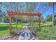 Picturesque walking path through a green park, shaded by trees and accented by a wooden pergola at 5313 Sanderling Ridge Dr, Lithia, FL 33547