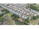 An aerial view shows the layout of the neighborhood, trees, pond and other community amenities at 5524 Betmar Dr, Zephyrhills, FL 33542