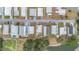 Aerial view of homes shows the layout of the neighborhood and the proximity to a pond at 5524 Betmar Dr, Zephyrhills, FL 33542