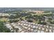 An aerial view shows the location of the home in a neighborhood near a pond and the golf course at 5524 Betmar Dr, Zephyrhills, FL 33542