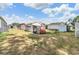 A spacious backyard features multiple storage sheds, seating, and mature trees, perfect for relaxing at 5524 Betmar Dr, Zephyrhills, FL 33542