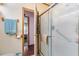 Bright bathroom features a glass shower and leads to the bedroom at 5524 Betmar Dr, Zephyrhills, FL 33542