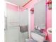 Bathroom with pink accents and an enclosed shower at 5524 Betmar Dr, Zephyrhills, FL 33542