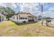 Cozy single-story home with a carport and green grass at 5524 Betmar Dr, Zephyrhills, FL 33542