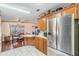 Bright kitchen featuring stainless steel refrigerator and view of dining area at 5524 Betmar Dr, Zephyrhills, FL 33542