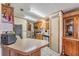 Functional kitchen featuring stainless steel appliances, tile floor, breakfast bar, and wood cabinets at 5524 Betmar Dr, Zephyrhills, FL 33542
