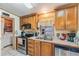 Bright kitchen featuring stainless steel appliances, and wood cabinets at 5524 Betmar Dr, Zephyrhills, FL 33542