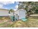 This property features a shed and chicken coop in the backyard with mature trees at 5524 Betmar Dr, Zephyrhills, FL 33542