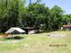 Large backyard with sheds, a chicken coop, and a fire pit, perfect for outdoor activities at 5602 N Dormany Rd, Plant City, FL 33565