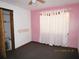 Bedroom featuring a pink accent wall, carpeted floors, and closet, offering a cozy atmosphere at 5602 N Dormany Rd, Plant City, FL 33565