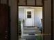 Outdoor entrance featuring a white door, complemented by a staircase and simple, elegant railing at 5602 N Dormany Rd, Plant City, FL 33565