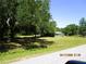 Scenic view of a home surrounded by mature trees and a spacious front yard at 5602 N Dormany Rd, Plant City, FL 33565
