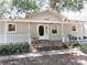 Inviting single-story home featuring a charming front porch and well-maintained landscaping at 5602 N Dormany Rd, Plant City, FL 33565