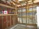 Garage interior with exposed beams, wooden shelving, offering storage and potential for customization at 5602 N Dormany Rd, Plant City, FL 33565