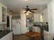 Functional kitchen featuring white cabinets, a dining table, and updated appliances at 5602 N Dormany Rd, Plant City, FL 33565