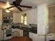 Efficient kitchen design with white cabinets, dark countertops, and modern stainless steel appliances at 5602 N Dormany Rd, Plant City, FL 33565