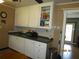 Traditional kitchen featuring white cabinets, neutral countertop, and a view to the doorway at 5602 N Dormany Rd, Plant City, FL 33565
