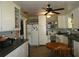 Functional kitchen with white cabinets, appliances, ceiling fan, and a breakfast table for everyday meals at 5602 N Dormany Rd, Plant City, FL 33565