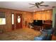 Welcoming living room with warm paneling, large windows, a ceiling fan, and comfortable seating at 5602 N Dormany Rd, Plant City, FL 33565