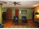 Comfortable living room with hardwood floors, muted green walls, and traditional decor at 5602 N Dormany Rd, Plant City, FL 33565