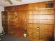 Living room featuring wood paneling and built-in shelving, creating a functional and stylish space at 5602 N Dormany Rd, Plant City, FL 33565