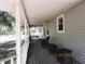 Inviting covered porch with wicker furniture, offering a relaxing outdoor space at 5602 N Dormany Rd, Plant City, FL 33565
