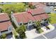 Aerial view of a townhome featuring a brown roof and mature trees at 621 Duchess Blvd, Dunedin, FL 34698