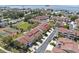 Aerial view of townhouses with lush landscaping, tennis courts, and waterfront access at 621 Duchess Blvd, Dunedin, FL 34698