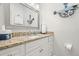 Charming bathroom features granite counters, a white vanity, and nautical decor accents at 621 Duchess Blvd, Dunedin, FL 34698