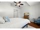 Cozy bedroom with a ceiling fan, television and blue accent chair at 621 Duchess Blvd, Dunedin, FL 34698