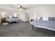 Spacious bedroom featuring tiled floors, two beds, neutral walls, and ceiling fan at 621 Duchess Blvd, Dunedin, FL 34698
