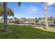 Waterfront property featuring a private dock with boat slips and lush landscaping at 621 Duchess Blvd, Dunedin, FL 34698