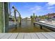 Dock with boat lift and views of nearby luxury waterfront homes at 621 Duchess Blvd, Dunedin, FL 34698