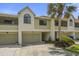 Inviting townhouse with attached garage and well-manicured landscaping at 621 Duchess Blvd, Dunedin, FL 34698
