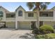 Charming two-story townhome with a well-manicured lawn and a one-car garage at 621 Duchess Blvd, Dunedin, FL 34698