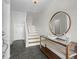 Bright foyer with tile flooring, console table with mirror and staircase at 621 Duchess Blvd, Dunedin, FL 34698