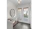 Bright foyer with tile flooring, console table with mirror and exterior door at 621 Duchess Blvd, Dunedin, FL 34698