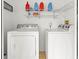 Functional laundry room equipped with a washer, dryer, and shelving for storage at 621 Duchess Blvd, Dunedin, FL 34698
