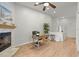 Living room with a fireplace, ceiling fan, and light wood flooring at 621 Duchess Blvd, Dunedin, FL 34698